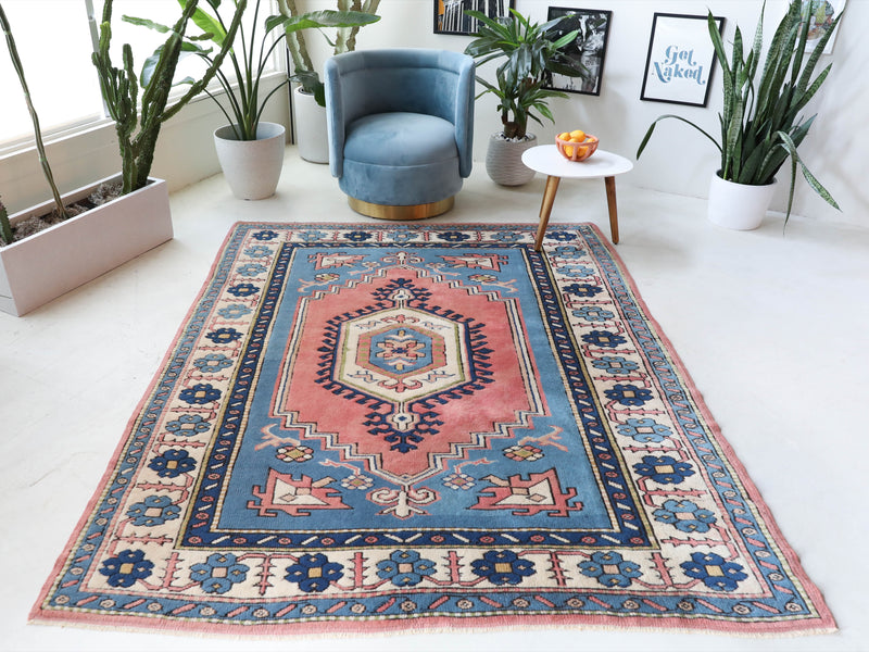 Vintage Turkish rug in living room setting, old rug, antique rug, pastel colors, faded colors, Turkish rug, vintage rug, soft rug, Portland, Oregon, rug store, rug shop, local shop