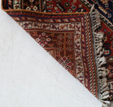 Antique Persian  rug in a living room setting, pile rug, vintage rug, portland, rug shop, bright colors, wild shaman, soft rug, bold color, Portland, Oregon, rug store, rug shop, local shop, antique rug, Persian rug, handmade rug, wool rug, distressed rug