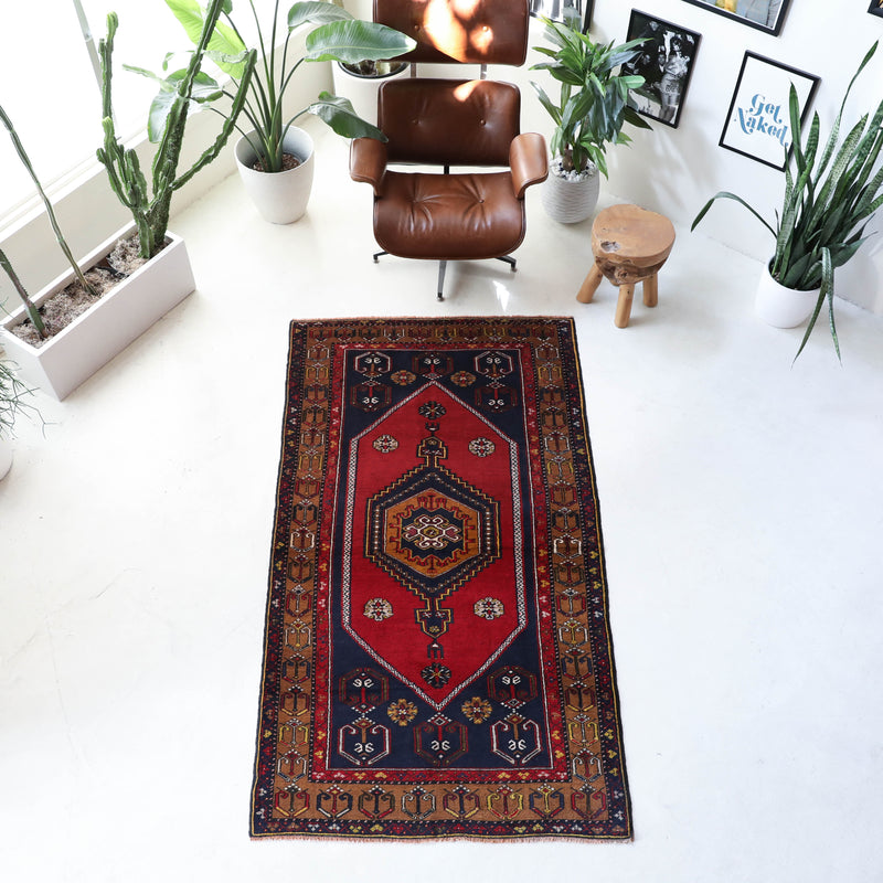 Vintage Turkish rug in a living room setting, pile rug, Turkish rug, vintage rug, portland, rug shop, bright colors, wild shaman, soft rug, bold color, Portland, Oregon, rug store, rug shop, local shop, antique rug