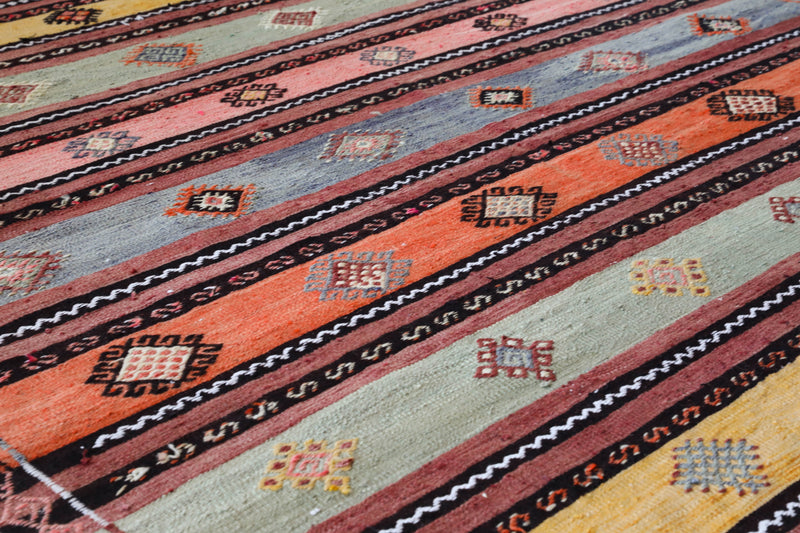  Vintage kilim rug in room decor setting, old rug, antique rug, pastel colors, faded colors, Turkish rug, vintage rug, soft rug, Portland, Oregon, rug store, rug shop, local shop, bold colors, bright colors, faded colors