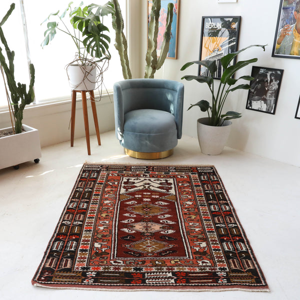 Vintage Turkish rug in a living room setting, pile rug, Turkish rug, vintage rug, portland, rug shop, bright colors, wild shaman, soft rug, bold color, Portland, Oregon, rug store, rug shop, local shop, antique rug