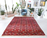 Antique Turkmen rug in a living room setting, pile rug, Turkish rug, vintage rug, portland, rug shop, bright colors, wild shaman, soft rug, bold color, Portland, Oregon, rug store, rug shop, local shop, antique rug