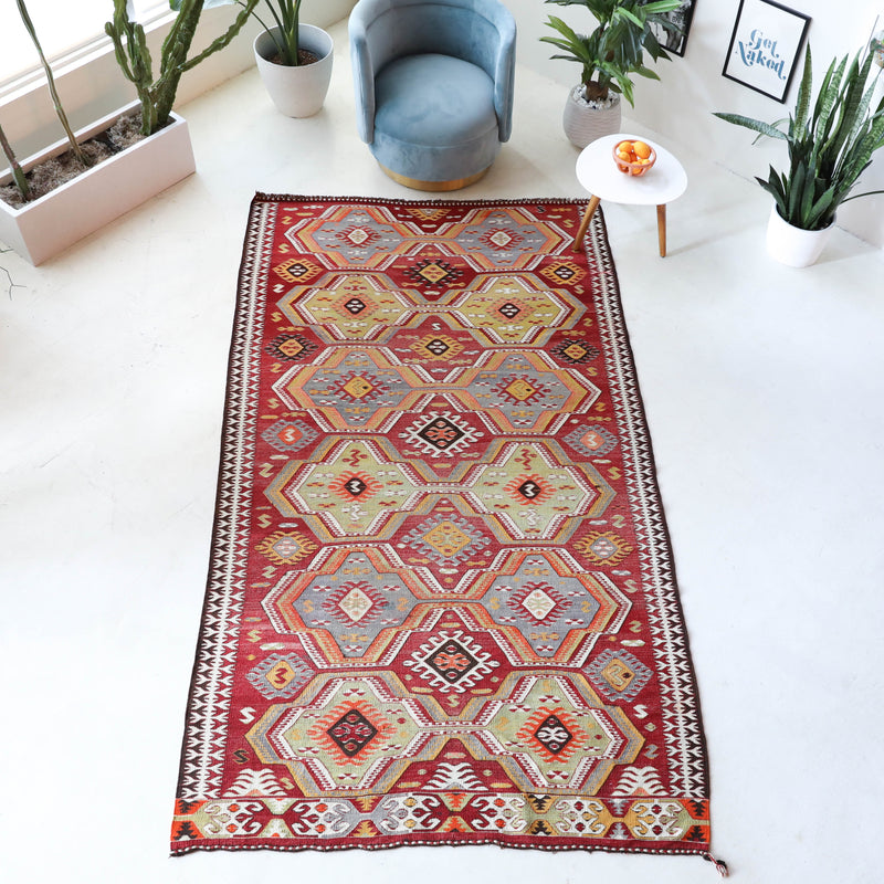 Vintage kilim rug in living room setting, old rug, antique rug, pastel colors, faded colors, Turkish rug, vintage rug, soft rug, Portland, Oregon, rug store, rug shop, local shop, earthy tones, earthy colors, warm colors