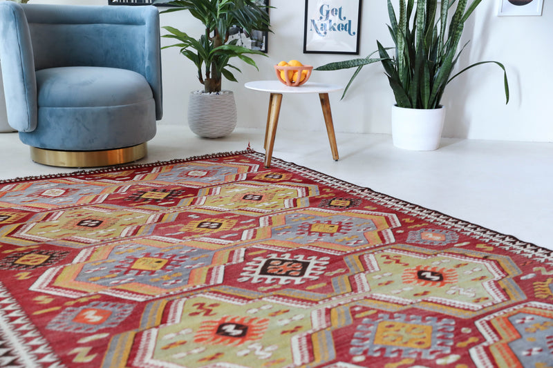 Vintage kilim rug in living room setting, old rug, antique rug, pastel colors, faded colors, Turkish rug, vintage rug, soft rug, Portland, Oregon, rug store, rug shop, local shop, earthy tones, earthy colors, warm colors