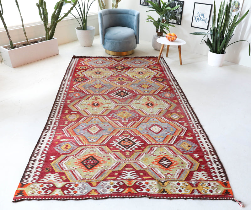 Vintage kilim rug in living room setting, old rug, antique rug, pastel colors, faded colors, Turkish rug, vintage rug, soft rug, Portland, Oregon, rug store, rug shop, local shop, earthy tones, earthy colors, warm colors