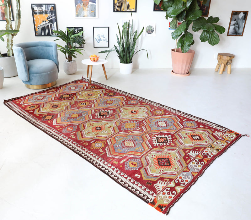 Vintage kilim rug in living room setting, old rug, antique rug, pastel colors, faded colors, Turkish rug, vintage rug, soft rug, Portland, Oregon, rug store, rug shop, local shop, earthy tones, earthy colors, warm colors