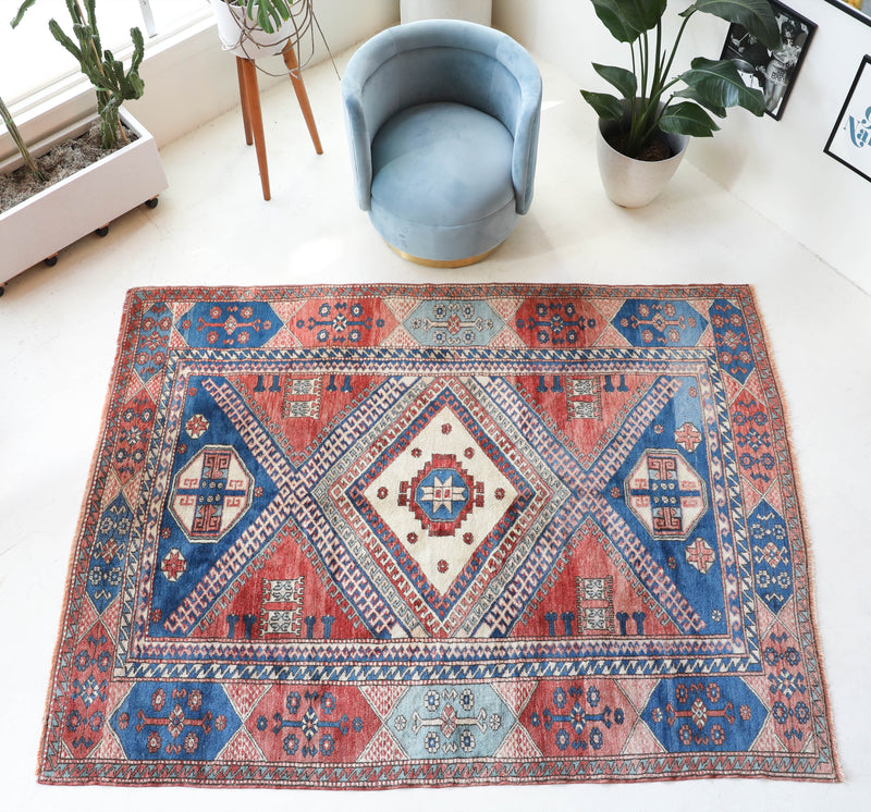 Vintage Turkish rug in living room setting, old rug, antique rug, pastel colors, faded colors, Turkish rug, vintage rug, soft rug, Portland, Oregon, rug store, rug shop, local shop