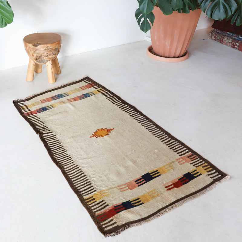  Vintage kilim rug in living room setting, old rug, antique rug, pastel colors, faded colors, Turkish rug, vintage rug, soft rug, Portland, Oregon, rug store, rug shop, local shop, earthy tones, earthy colors, warm colors