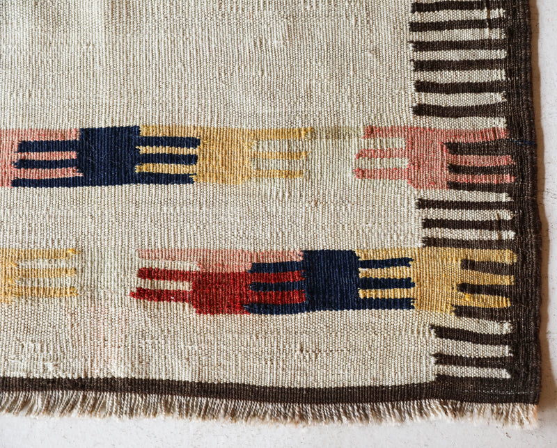  Vintage kilim rug in living room setting, old rug, antique rug, pastel colors, faded colors, Turkish rug, vintage rug, soft rug, Portland, Oregon, rug store, rug shop, local shop, earthy tones, earthy colors, warm colors