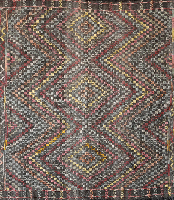 Vintage kilim rug in living room setting, old rug, antique rug, pastel colors, faded colors, Turkish rug, vintage rug, soft rug, Portland, Oregon, rug store, rug shop, local shop, earthy tones, earthy colors, warm colors