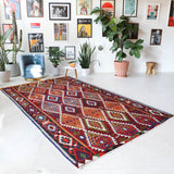 Vintage kilim rug in living room setting, bright colors, wild shaman, soft rug, bold color, Portland, Oregon, rug store, rug shop, local shop, vintage rug, modern kilim, warm colors