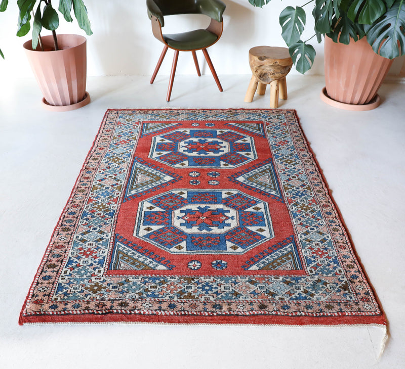 Vintage Turkish rug in living room setting, old rug, antique rug, pastel colors, faded colors, Turkish rug, vintage rug, soft rug, Portland, Oregon, rug store, rug shop, local shop