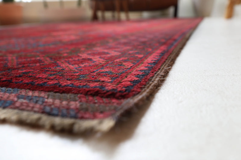 Antique Turkmen rug in a living room setting, pile rug, Turkish rug, vintage rug, portland, rug shop, bright colors, wild shaman, soft rug, bold color, Portland, Oregon, rug store, rug shop, local shop, antique rug