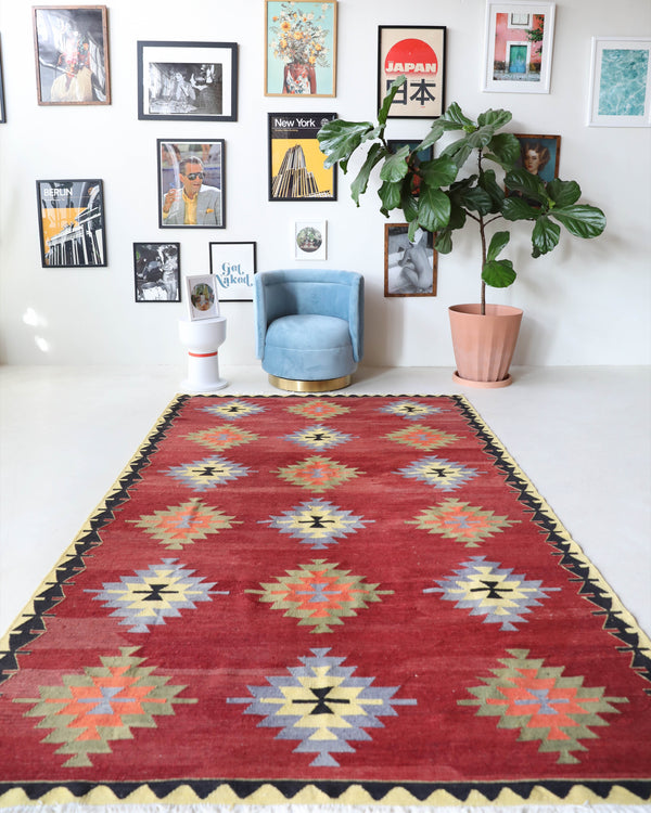 Vintage kilim rug in room decor setting, old rug, antique rug, pastel colors, faded colors, Turkish rug, vintage rug, soft rug, Portland, Oregon, rug store, rug shop, local shop, bold colors, bright colors, faded colors