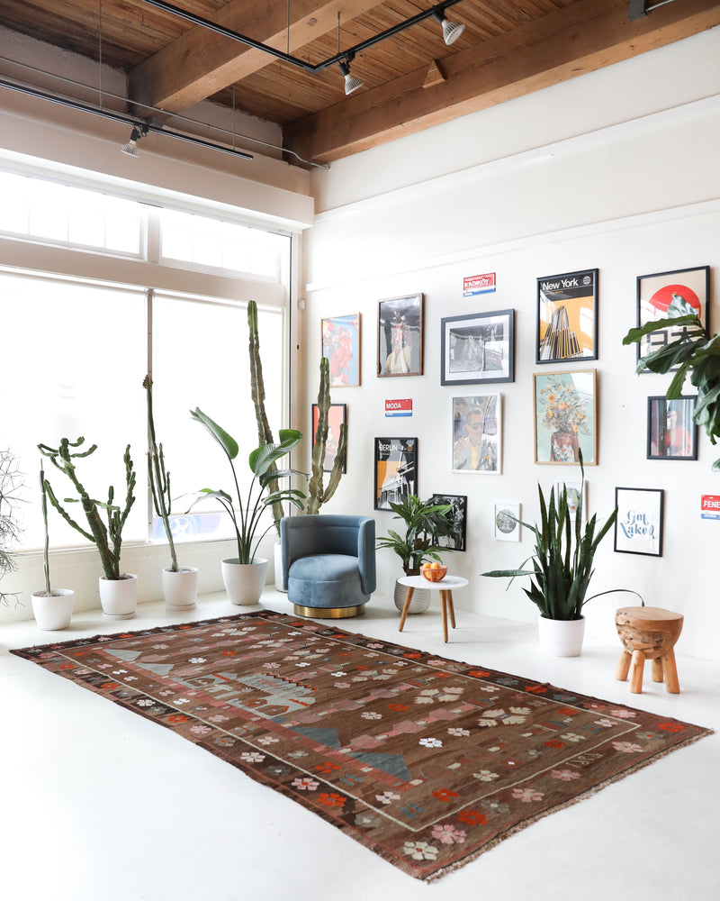 Vintage kilim rug in living room setting, old rug, antique rug, pastel colors, faded colors, Turkish rug, vintage rug, soft rug, Portland, Oregon, rug store, rug shop, local shop, earthy tones, earthy colors, warm colors