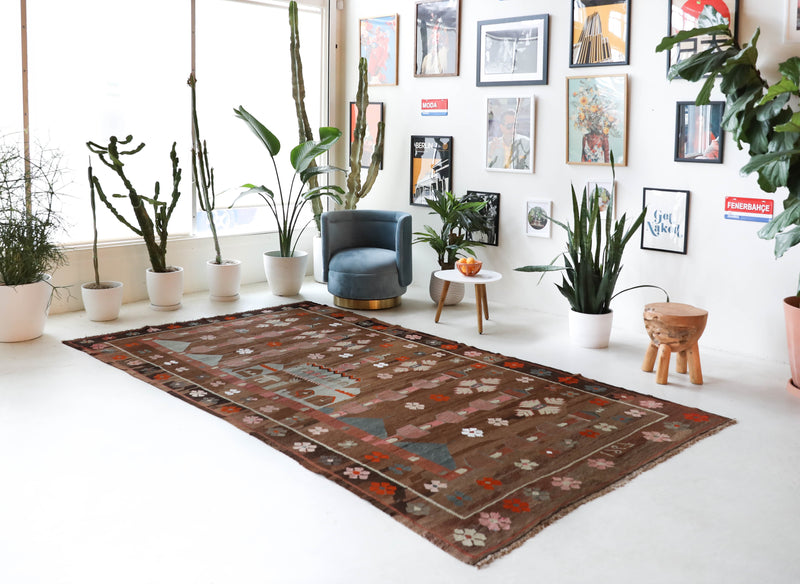 Vintage kilim rug in living room setting, old rug, antique rug, pastel colors, faded colors, Turkish rug, vintage rug, soft rug, Portland, Oregon, rug store, rug shop, local shop, earthy tones, earthy colors, warm colors