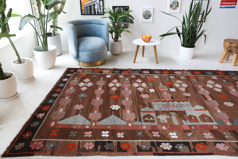 Vintage kilim rug in living room setting, old rug, antique rug, pastel colors, faded colors, Turkish rug, vintage rug, soft rug, Portland, Oregon, rug store, rug shop, local shop, earthy tones, earthy colors, warm colors