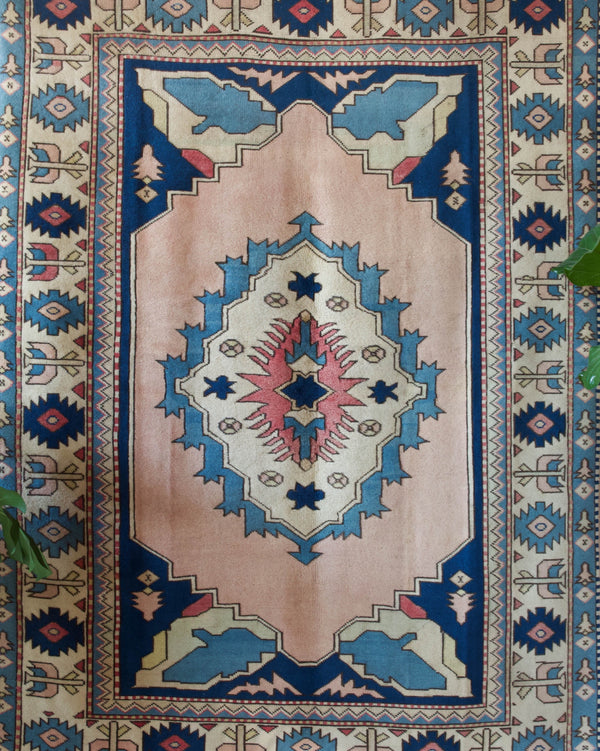 Vintage Turkish rug in living room setting, old rug, antique rug, pastel colors, faded colors, Turkish rug, vintage rug, soft rug, Portland, Oregon, rug store, rug shop, local shop