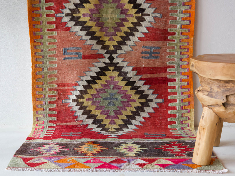  Vintage Turkish runner rug in a living room setting, pile rug, Turkish rug, vintage rug, portland, rug shop, bright colors, wild shaman, soft rug, bold color, Portland, Oregon, rug store, rug shop, local shop, antique rug