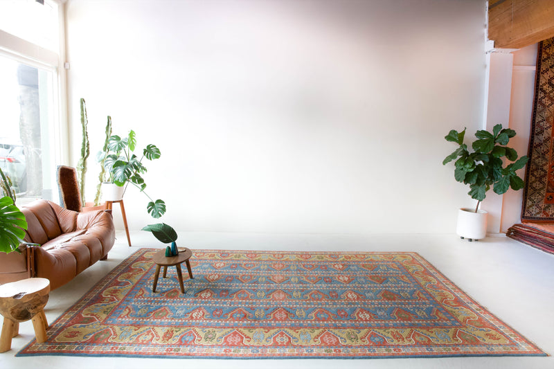 Vintage Turkish rug in a living room setting, pile rug, Turkish rug, vintage rug, portland, rug shop, bright colors, wild shaman, soft rug, bold color, Portland, Oregon, rug store, rug shop, local shop, antique rug, 