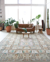 Area rug in a living room setting, pile rug, Turkish rug, old rug, antique rug, pastel colors, faded colors, Turkish rug, vintage rug, soft rug, Portland, Oregon, rug store, rug shop, local shop, pastel colors, warm colors