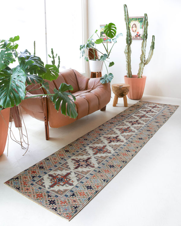 Vintage Turkish runner rug in living room setting, old rug, antique rug, pastel colors, faded colors, Turkish rug, vintage rug, soft rug, Portland, Oregon, rug store, rug shop, local shop