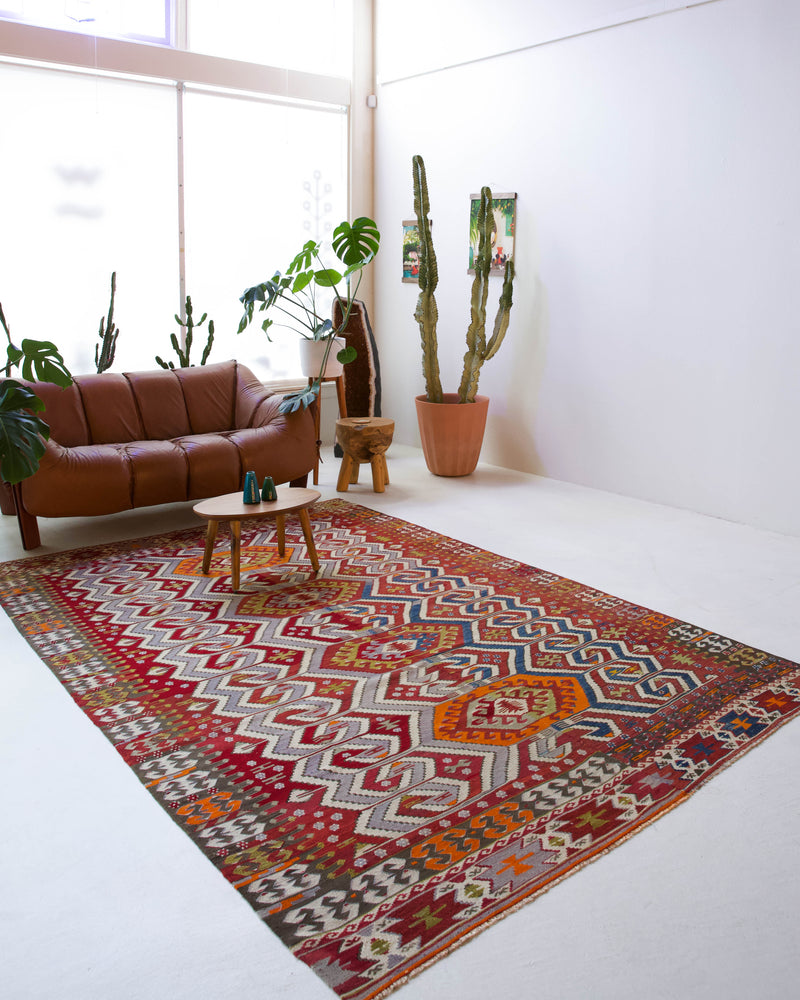 Vintage kilim rug in room decor setting, old rug, antique rug, pastel colors, faded colors, Turkish rug, vintage rug, soft rug, Portland, Oregon, rug store, rug shop, local shop, bold colors, bright colors, faded colors, antique kilim