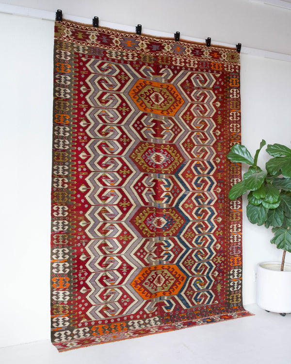 Vintage kilim rug in room decor setting, old rug, antique rug, pastel colors, faded colors, Turkish rug, vintage rug, soft rug, Portland, Oregon, rug store, rug shop, local shop, bold colors, bright colors, faded colors, antique kilim