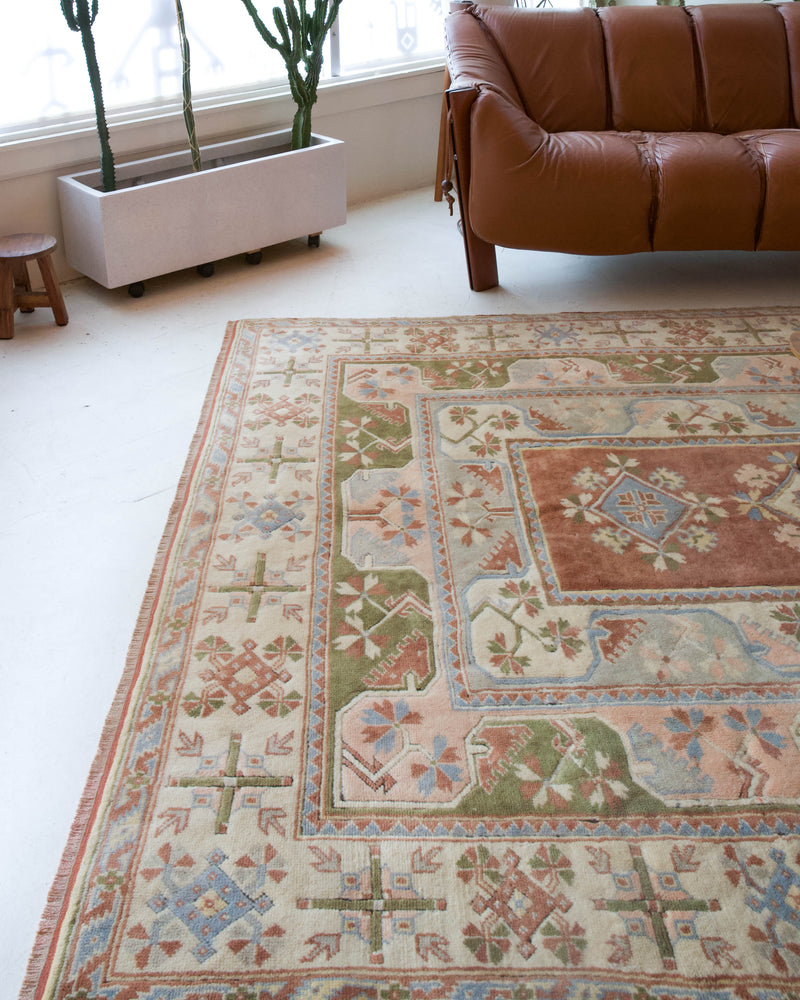 Vintage Turkish rug in living room setting, old rug, antique rug, pastel colors, faded colors, Turkish rug, vintage rug, soft rug, Portland, Oregon, rug store, rug shop, local shop