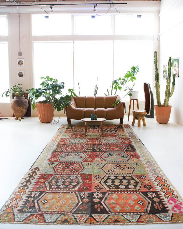 Vintage kilim rug in room decor setting, old rug, antique rug, pastel colors, faded colors, Turkish rug, vintage rug, soft rug, Portland, Oregon, rug store, rug shop, local shop, bold colors, bright colors, faded colors