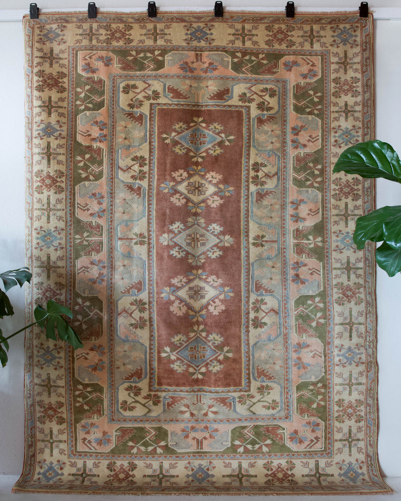 Vintage Turkish rug in living room setting, old rug, antique rug, pastel colors, faded colors, Turkish rug, vintage rug, soft rug, Portland, Oregon, rug store, rug shop, local shop