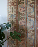 Vintage Turkish rug in living room setting, old rug, antique rug, pastel colors, faded colors, Turkish rug, vintage rug, soft rug, Portland, Oregon, rug store, rug shop, local shop