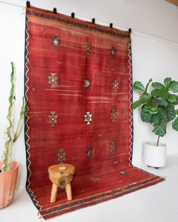 Vintage kilim rug in room decor setting, old rug, antique rug, pastel colors, faded colors, Turkish rug, vintage rug, soft rug, Portland, Oregon, rug store, rug shop, local shop, bold colors, bright colors, faded colors