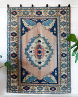 Vintage Turkish rug in living room setting, old rug, antique rug, pastel colors, faded colors, Turkish rug, vintage rug, soft rug, Portland, Oregon, rug store, rug shop, local shop