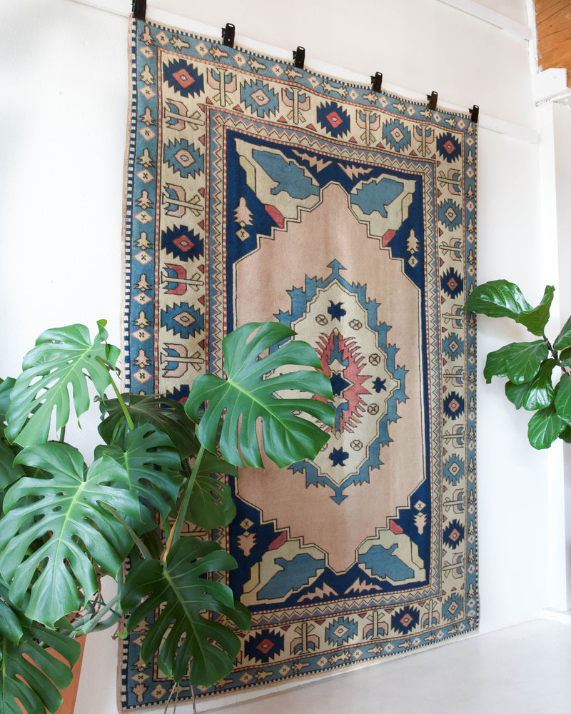 Vintage Turkish rug in living room setting, old rug, antique rug, pastel colors, faded colors, Turkish rug, vintage rug, soft rug, Portland, Oregon, rug store, rug shop, local shop