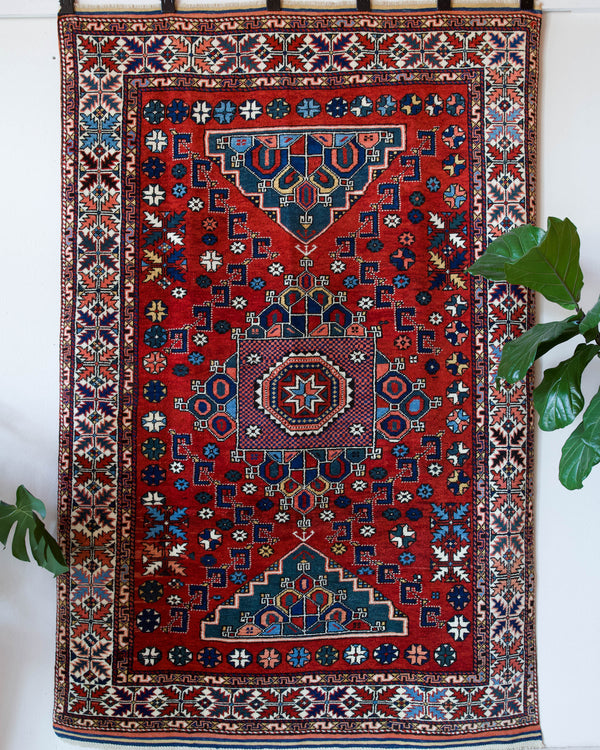 Vintage Turkish rug in a living room setting, pile rug, Turkish rug, vintage rug, portland, rug shop, bright colors, wild shaman, soft rug, bold color, Portland, Oregon, rug store, rug shop, local shop