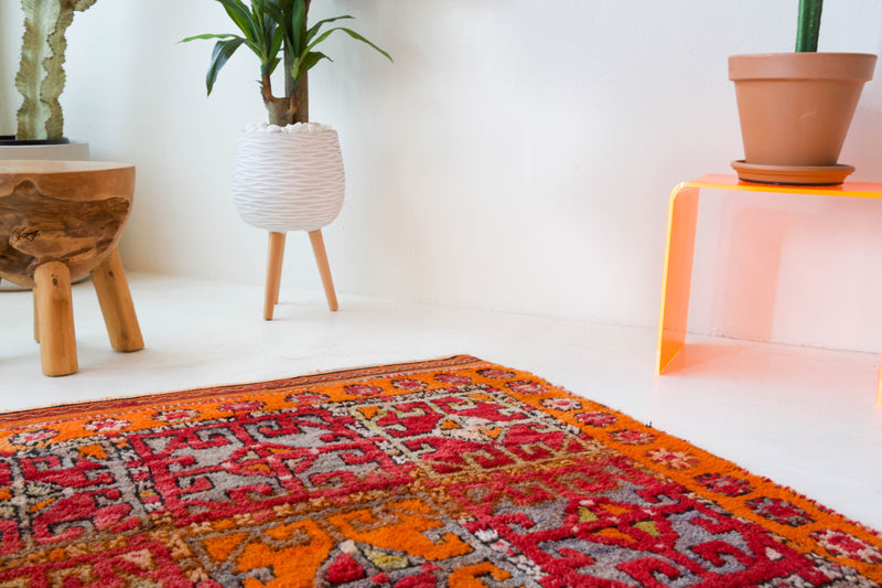 Vintage Turkish rug in a living room setting, pile rug, Turkish rug, vintage rug, portland, rug shop, bright colors, wild shaman, soft rug, bold color, Portland, Oregon, rug store, rug shop, local shop, antique rug