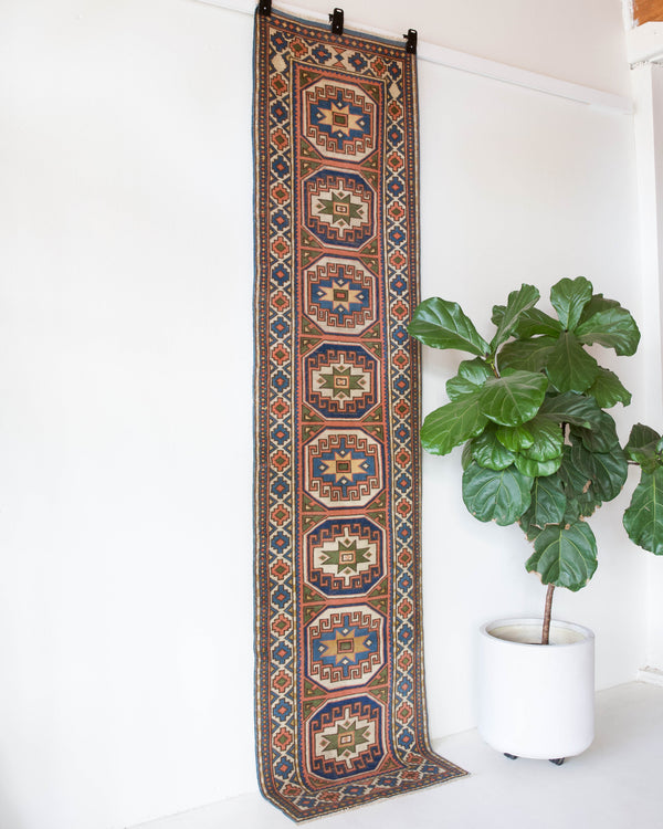 Vintage Turkish runner rug in living room setting, old rug, antique rug, pastel colors, faded colors, Turkish rug, vintage rug, soft rug, Portland, Oregon, rug store, rug shop, local shop