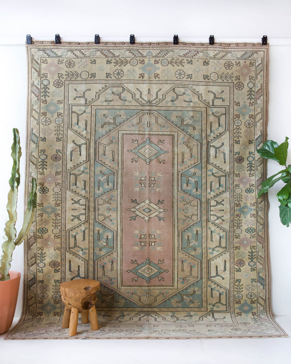 Vintage Turkish rug in living room setting, old rug, antique rug, pastel colors, faded colors, Turkish rug, vintage rug, soft rug, Portland, Oregon, rug store, rug shop, local shop