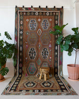 Vintage kilim rug in living room setting, old rug, antique rug, pastel colors, faded colors, Turkish rug, vintage rug, soft rug, Portland, Oregon, rug store, rug shop, local shop, earthy tones, earthy colors, warm colors