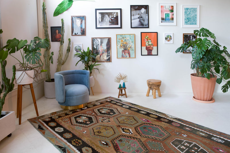 Vintage kilim rug in living room setting, old rug, antique rug, pastel colors, faded colors, Turkish rug, vintage rug, soft rug, Portland, Oregon, rug store, rug shop, local shop, earthy tones, earthy colors, warm colors