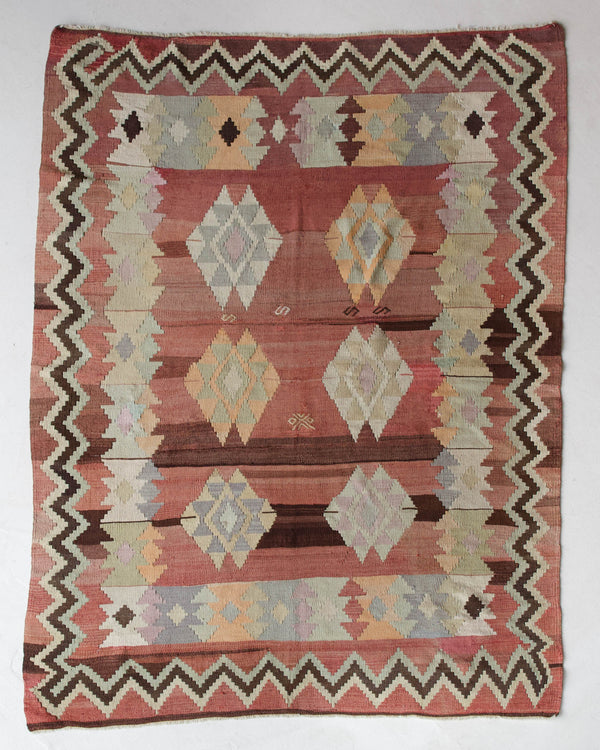 Vintage kilim rug in room decor setting, old rug, antique rug, pastel colors, faded colors, Turkish rug, vintage rug, soft rug, Portland, Oregon, rug store, rug shop, local shop, bold colors, bright colors, faded colors