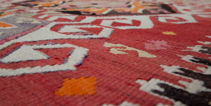 Vintage kilim rug in living room setting, old rug, antique rug, pastel colors, faded colors, Turkish rug, vintage rug, soft rug, Portland, Oregon, rug store, rug shop, local shop, earthy tones, earthy colors, warm colors