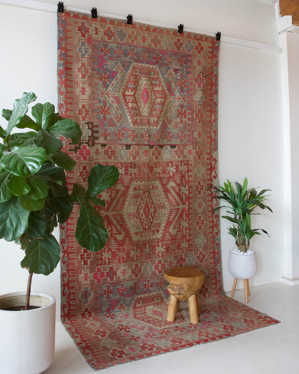 Vintage kilim rug in living room setting, old rug, antique rug, pastel colors, faded colors, Turkish rug, vintage rug, soft rug, Portland, Oregon, rug store, rug shop, local shop, earthy tones, earthy colors, warm colors