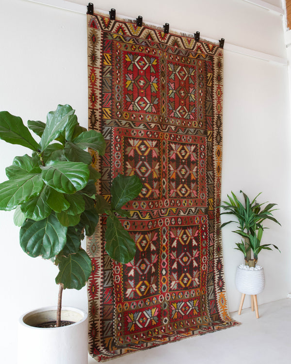 Vintage kilim rug in living room setting, old rug, antique rug, pastel colors, faded colors, Turkish rug, vintage rug, soft rug, Portland, Oregon, rug store, rug shop, local shop, earthy tones, earthy colors, warm colors