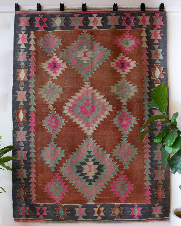 Vintage kilim rug in room decor setting, old rug, antique rug, pastel colors, faded colors, Turkish rug, vintage rug, soft rug, Portland, Oregon, rug store, rug shop, local shop, bold colors, bright colors, faded colors