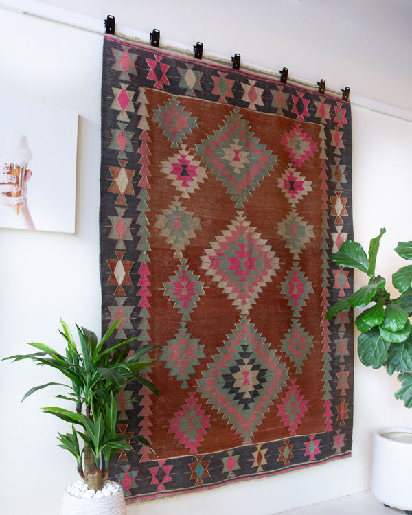 Vintage kilim rug in room decor setting, old rug, antique rug, pastel colors, faded colors, Turkish rug, vintage rug, soft rug, Portland, Oregon, rug store, rug shop, local shop, bold colors, bright colors, faded colors