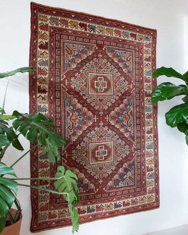 Vintage Turkish rug in living room setting, old rug, antique rug, pastel colors, faded colors, Turkish rug, vintage rug, soft rug, Portland, Oregon, rug store, rug shop, local shop