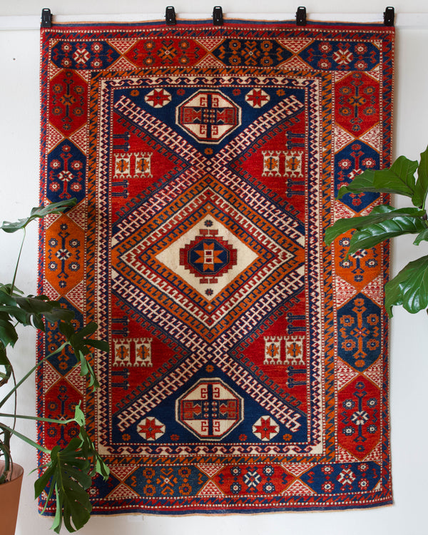 Vintage Turkish rug in a living room setting, pile rug, Turkish rug, vintage rug, portland, rug shop, bright colors, wild shaman, soft rug, bold color, Portland, Oregon, rug store, rug shop, local shop, antique rug