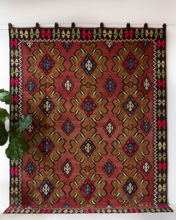 Vintage kilim rug in room decor setting, old rug, antique rug, pastel colors, faded colors, Turkish rug, vintage rug, soft rug, Portland, Oregon, rug store, rug shop, local shop, bold colors, bright colors, faded colors